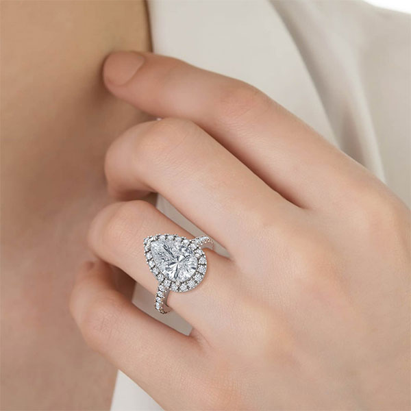 Pear Cut with Halo and Shoulder Diamonds set in a Cathedral Shank